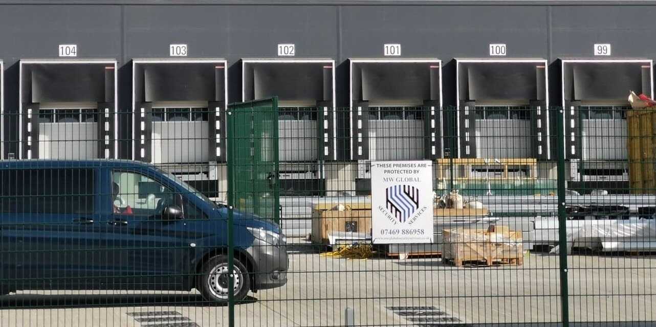 Security officer recording a patrol check at an Ipswich business site