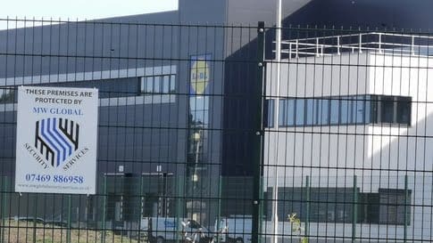 Security officer checking information at a controlled site entrance