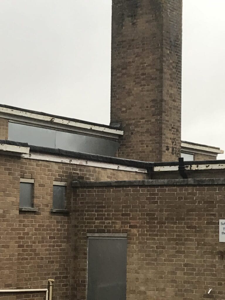 Commercial vacant property secured with fencing and MW Global Security signage