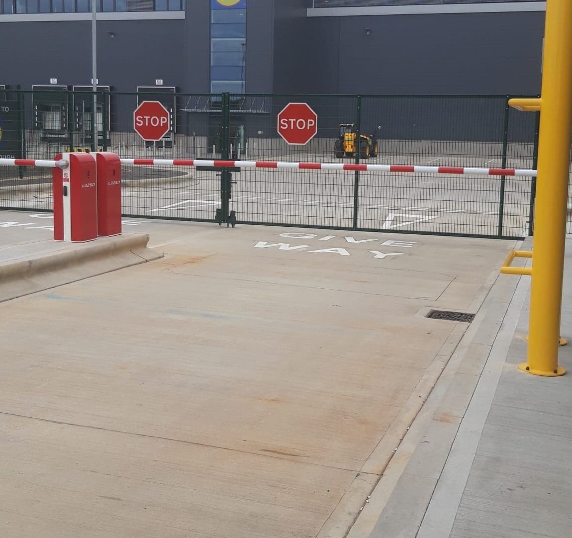 Warehouse security gatehouse with barriers and controlled access at logistics distribution centre