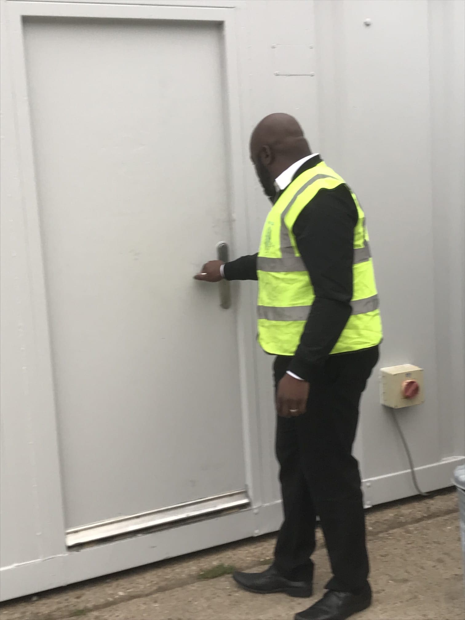 Security officer checking an external door during an overnight patrol
