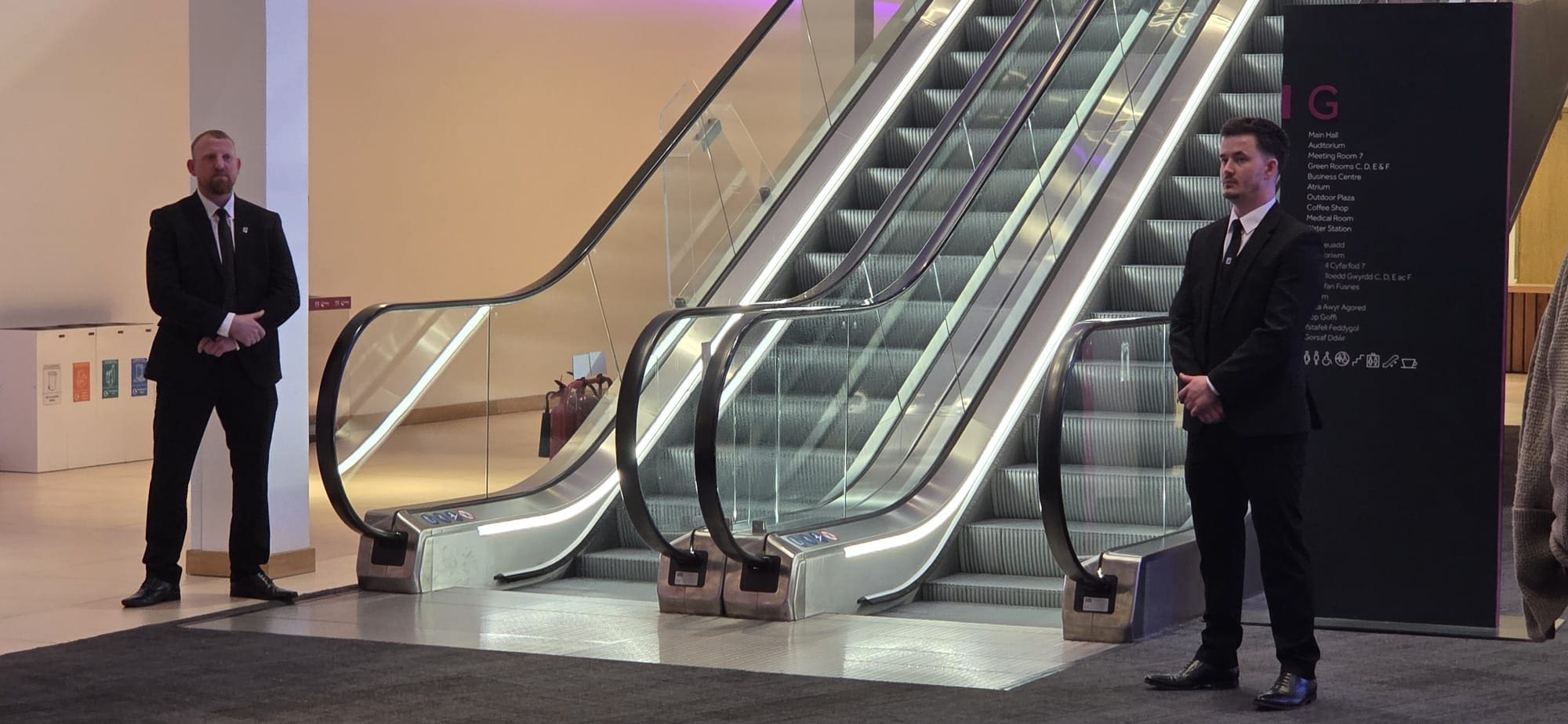 Two professional security officers providing access control at a corporate venue