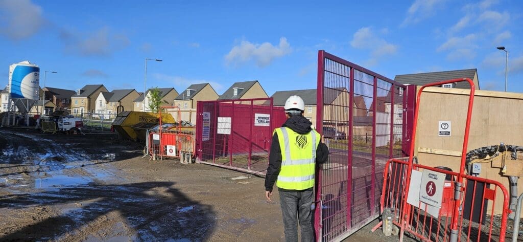 Security officer managing access at a construction site entrance