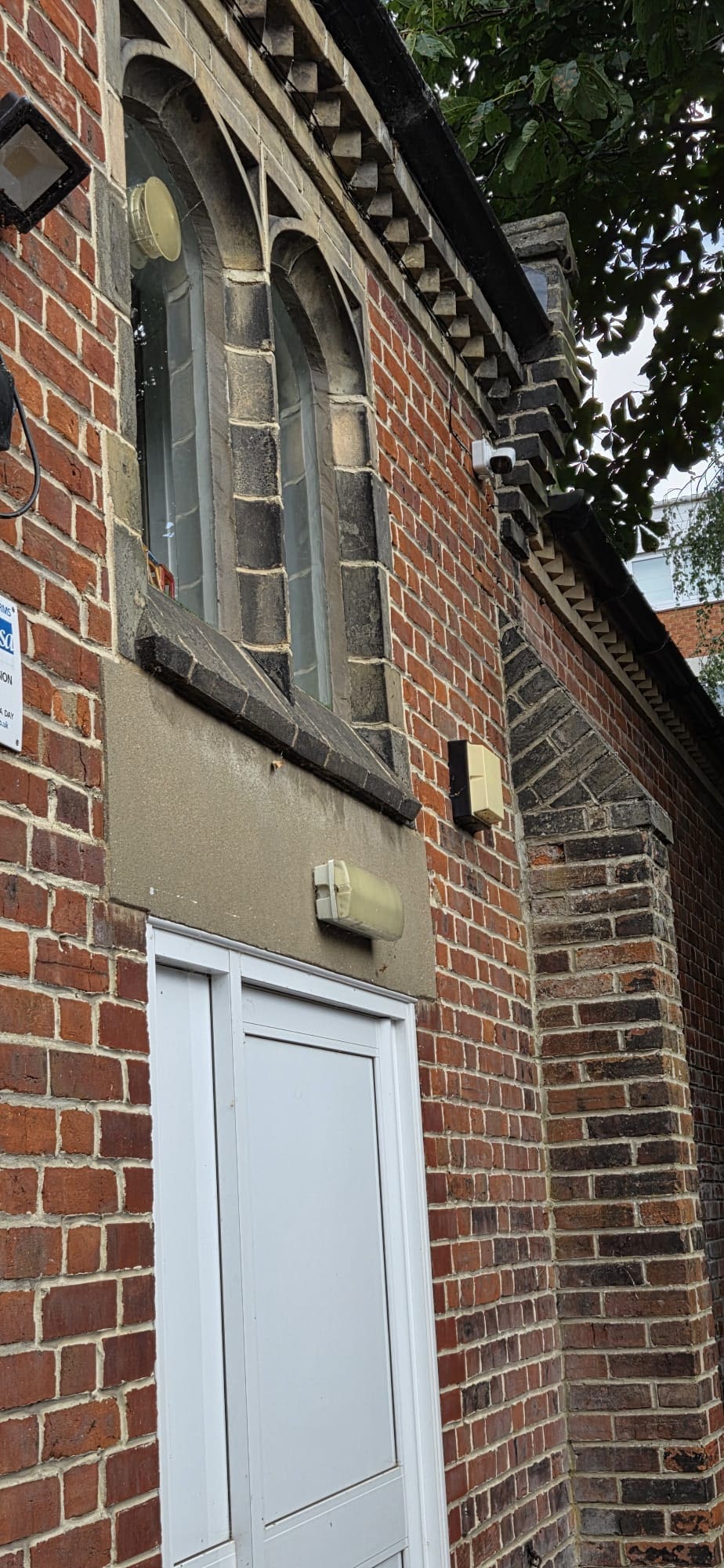 Permanent CCTV camera installed high on a commercial building