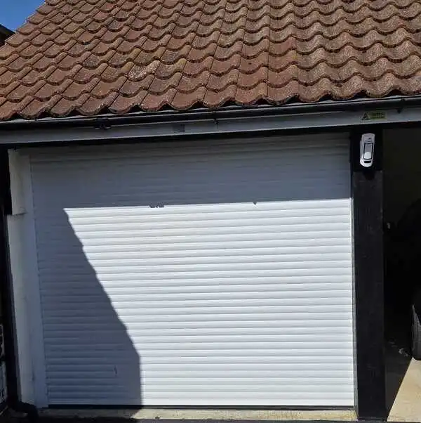 Wireless alarm detector protecting a detached garage and outbuilding