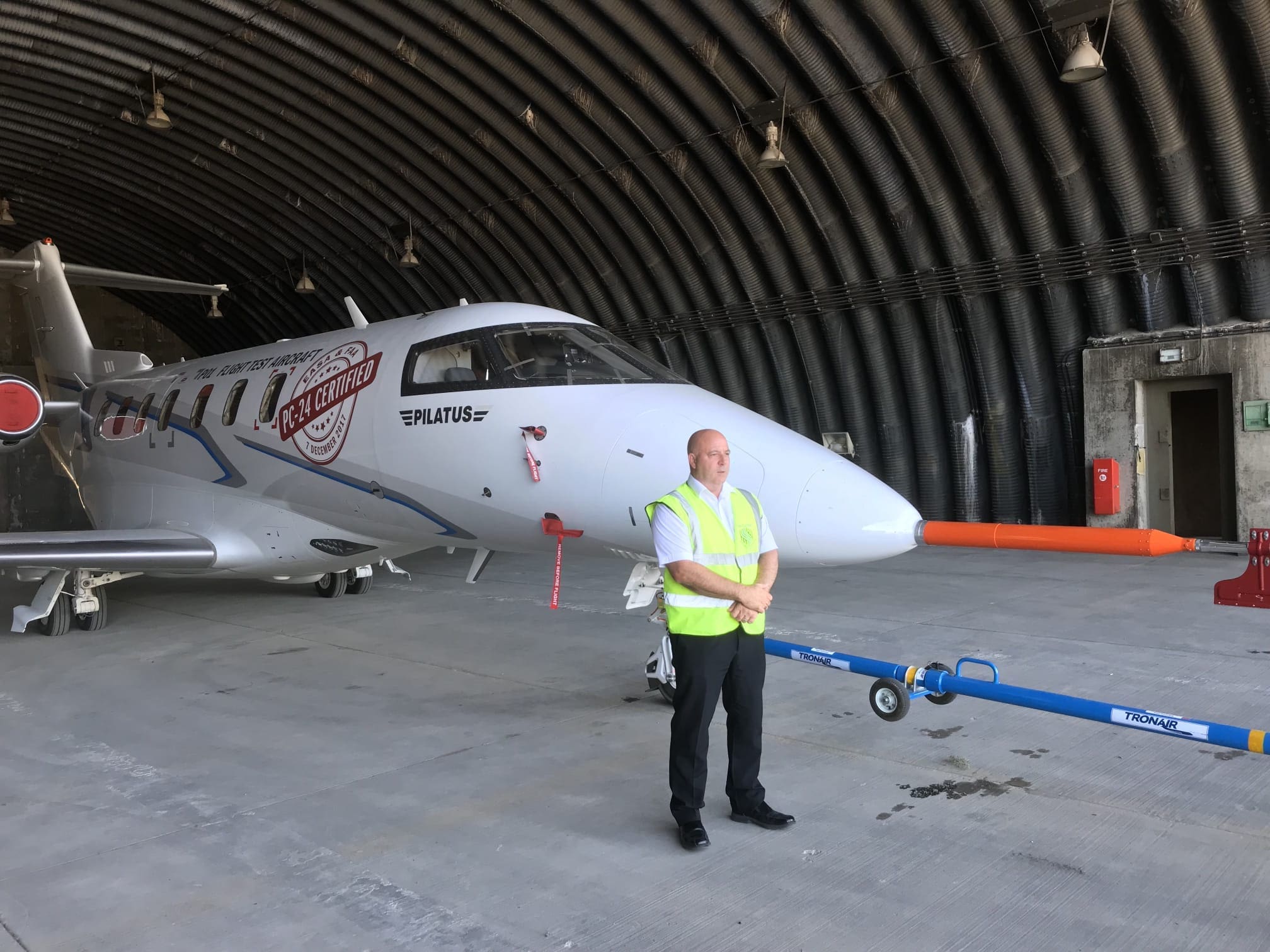 Leicester Security services, MW Global Security guard securing an aircraft hangar with aircraft parked.