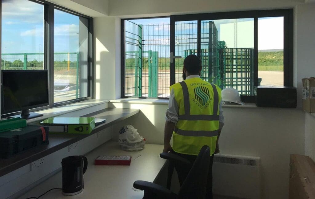MW Global security officer overseeing access from a commercial site gatehouse